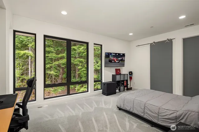 a bedroom with a bed and a large window