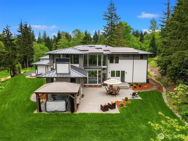 a view of a house with backyard sitting area and garden