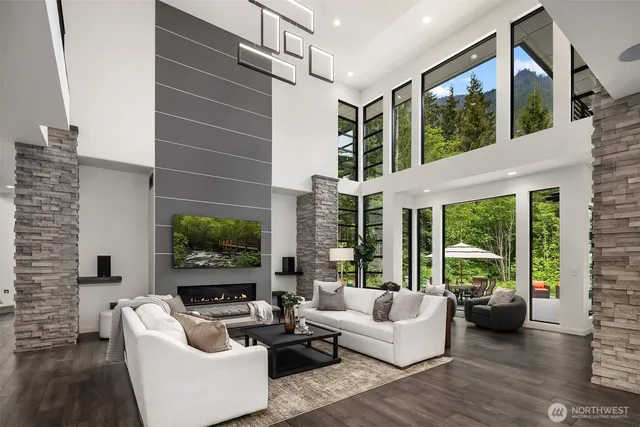 a living room with furniture fireplace and a large window
