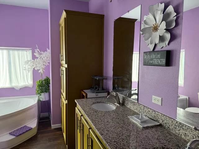 a kitchen with stainless steel appliances granite countertop a sink a stove and a microwave