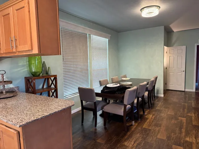a large bed sitting in a bedroom next to a larger window