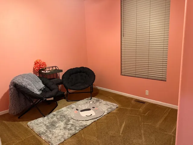 a living room with furniture and a dining table