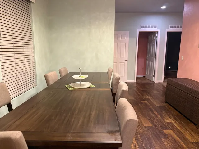 a view of a dining room with furniture and a potted plant