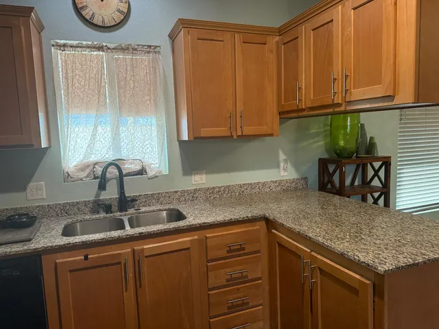 a bath tub sitting in front of a window and a mirror