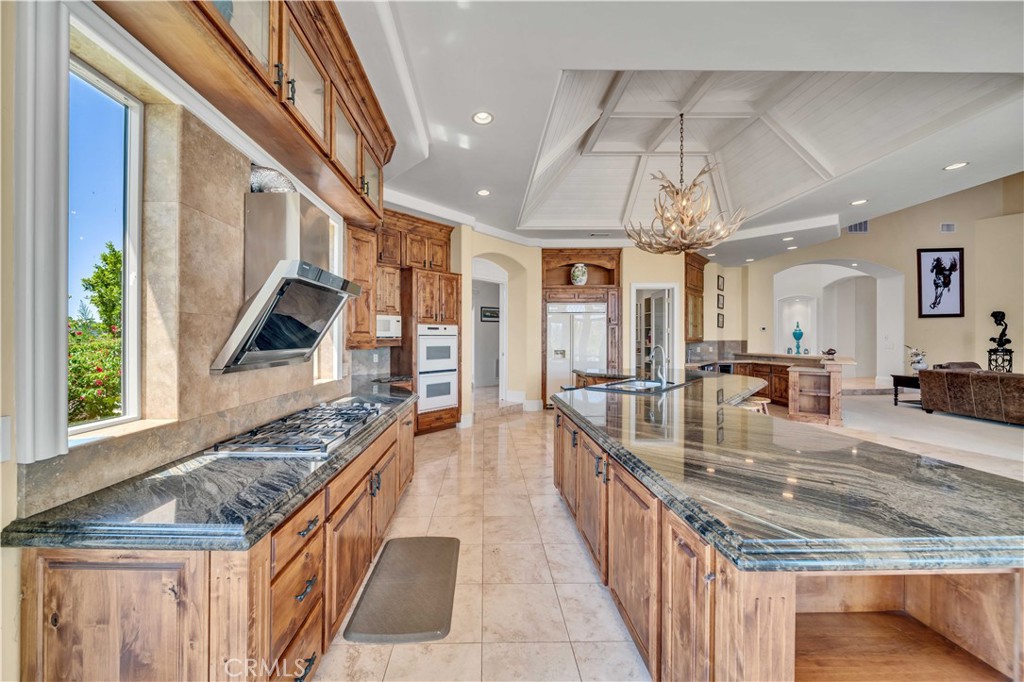 43744 Calle De Velardo Temecula, CA 92592 - Photo 11 of 60 a kitchen with stainless steel appliances granite countertop a lot of counter space and a sink