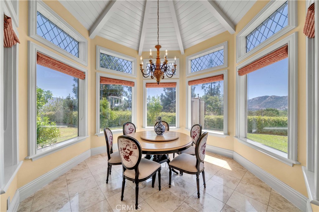 43744 Calle De Velardo Temecula, CA 92592 - Photo 14 of 60 a dining room with furniture large windows and a chandelier