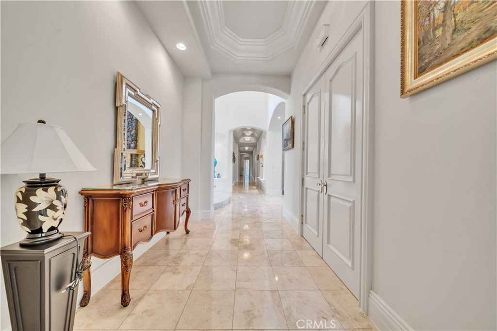 43744 Calle De Velardo Temecula, CA 92592 - Photo 15 of 60 a view of a hallway to a livingroom with furniture mirror and window