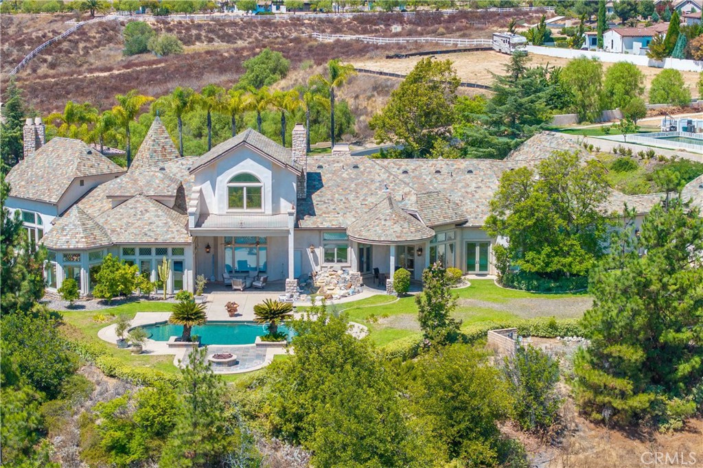 43744 Calle De Velardo Temecula, CA 92592 - Photo 2 of 60 a view of a house with swimming pool lawn chairs and a yard