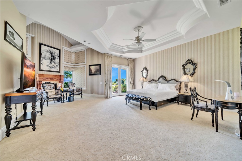 43744 Calle De Velardo Temecula, CA 92592 - Photo 22 of 60 a spacious bedroom with furniture and a large window