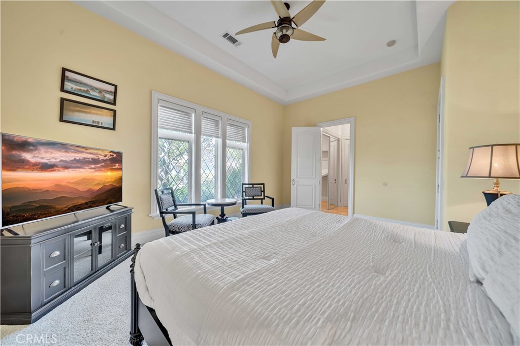 43744 Calle De Velardo Temecula, CA 92592 - Photo 29 of 60 a bedroom with a bed and a flat screen tv