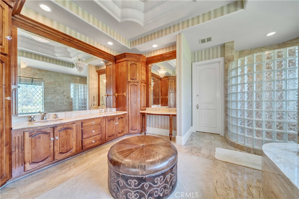 43744 Calle De Velardo Temecula, CA 92592 - Photo 33 of 60 a spacious bathroom with a tub sink and mirror