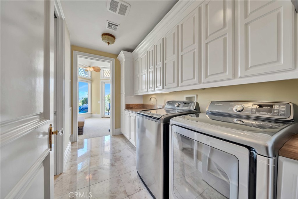 43744 Calle De Velardo Temecula, CA 92592 - Photo 40 of 60 a kitchen with stainless steel appliances granite countertop a stove a sink and a refrigerator