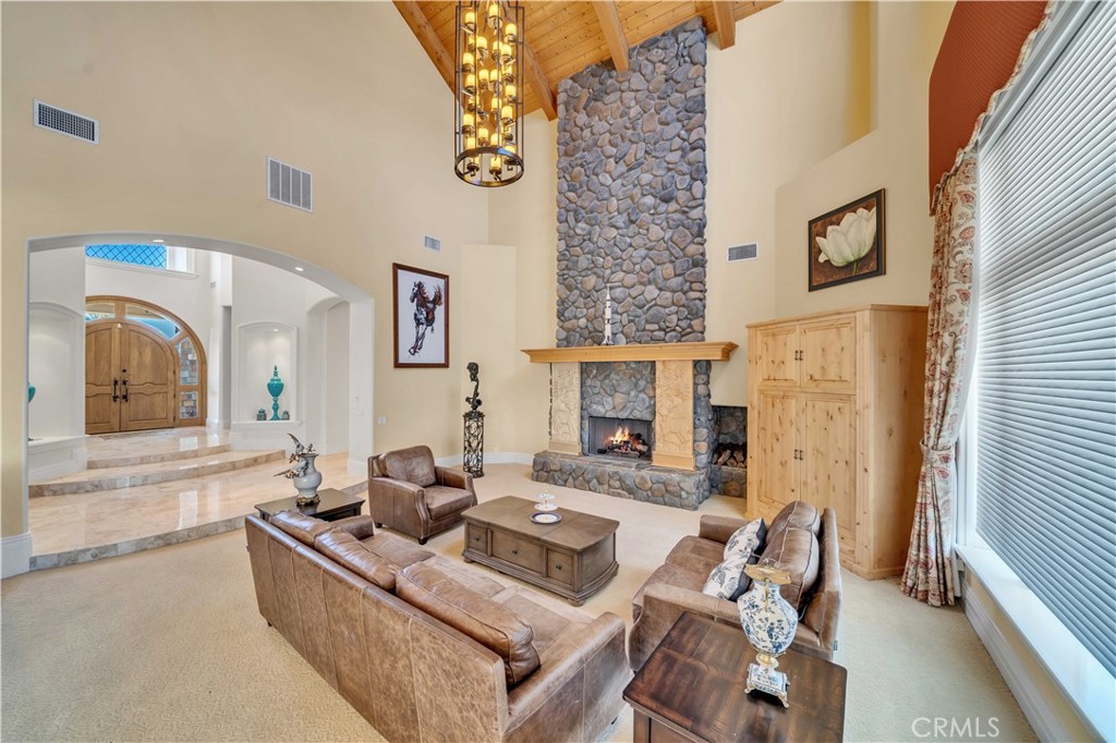 43744 Calle De Velardo Temecula, CA 92592 - Photo 6 of 60 a living room with fireplace furniture and a large window