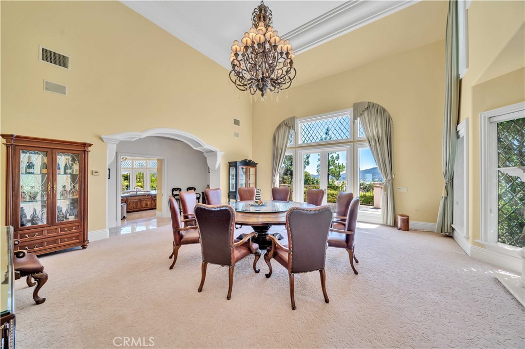 43744 Calle De Velardo Temecula, CA 92592 - Photo 8 of 60 a view of a dining room with furniture wooden floor and chandelier