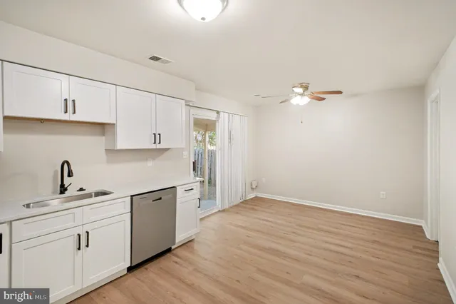 a kitchen with a sink cabinets and appliances