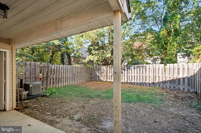 a view of a backyard with wooden fence