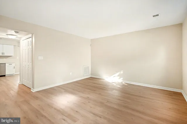 an empty room with wooden floor
