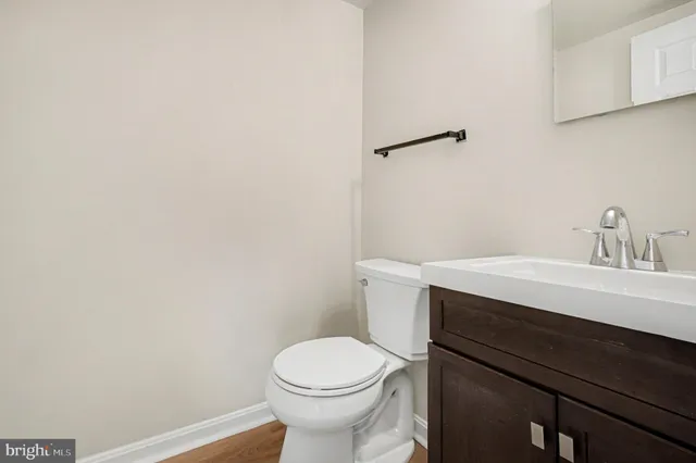 a bathroom with a sink a toilet and mirror