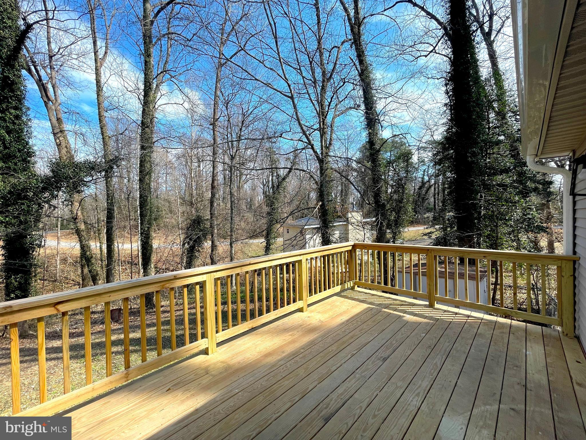 8264 Sycamore Road Lusby, MD 20657 - Photo 22 of 30 Deck overlooks rear yard backing to wooded privacy