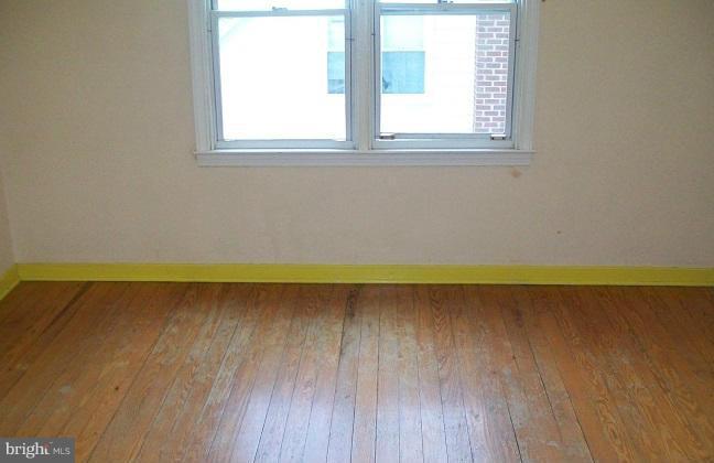 2815 Manoff Road Baltimore, MD 21227 - Photo 6 of 12 a view of a room with wooden floor and a window