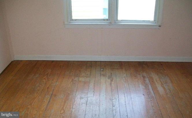2815 Manoff Road Baltimore, MD 21227 - Photo 7 of 12 a view of a room with wooden floor and window