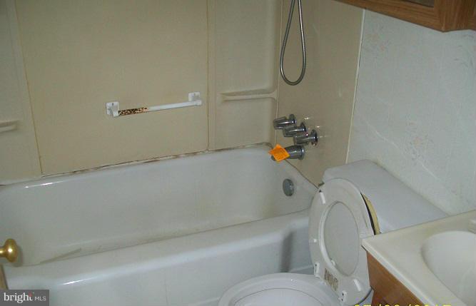 2815 Manoff Road Baltimore, MD 21227 - Photo 9 of 12 a bathroom with a bath tub with a toilet