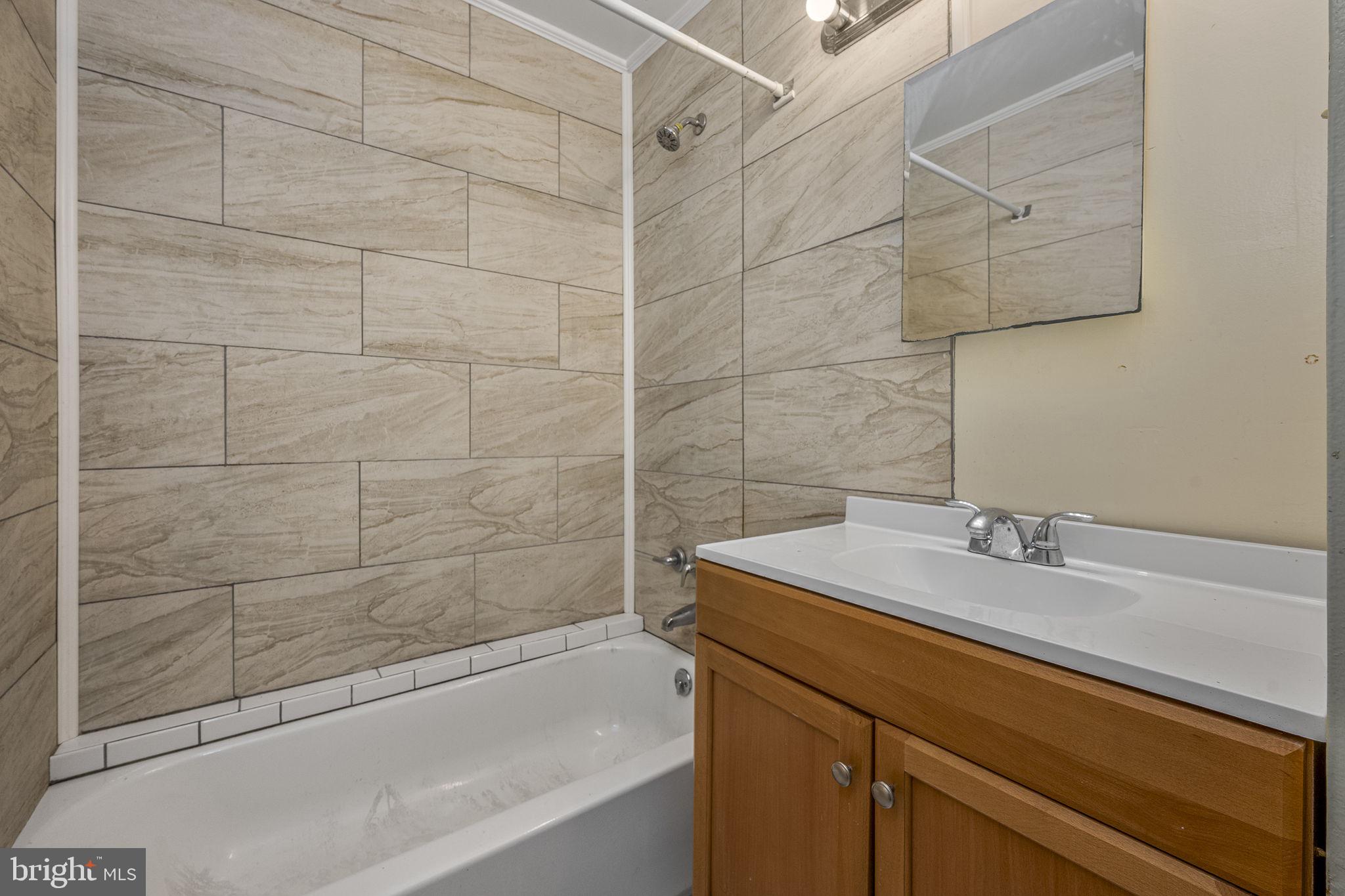 2550 Clothier Street Coatesville, PA 19320 - Photo 15 of 23 a bathroom with a sink and a bathtub