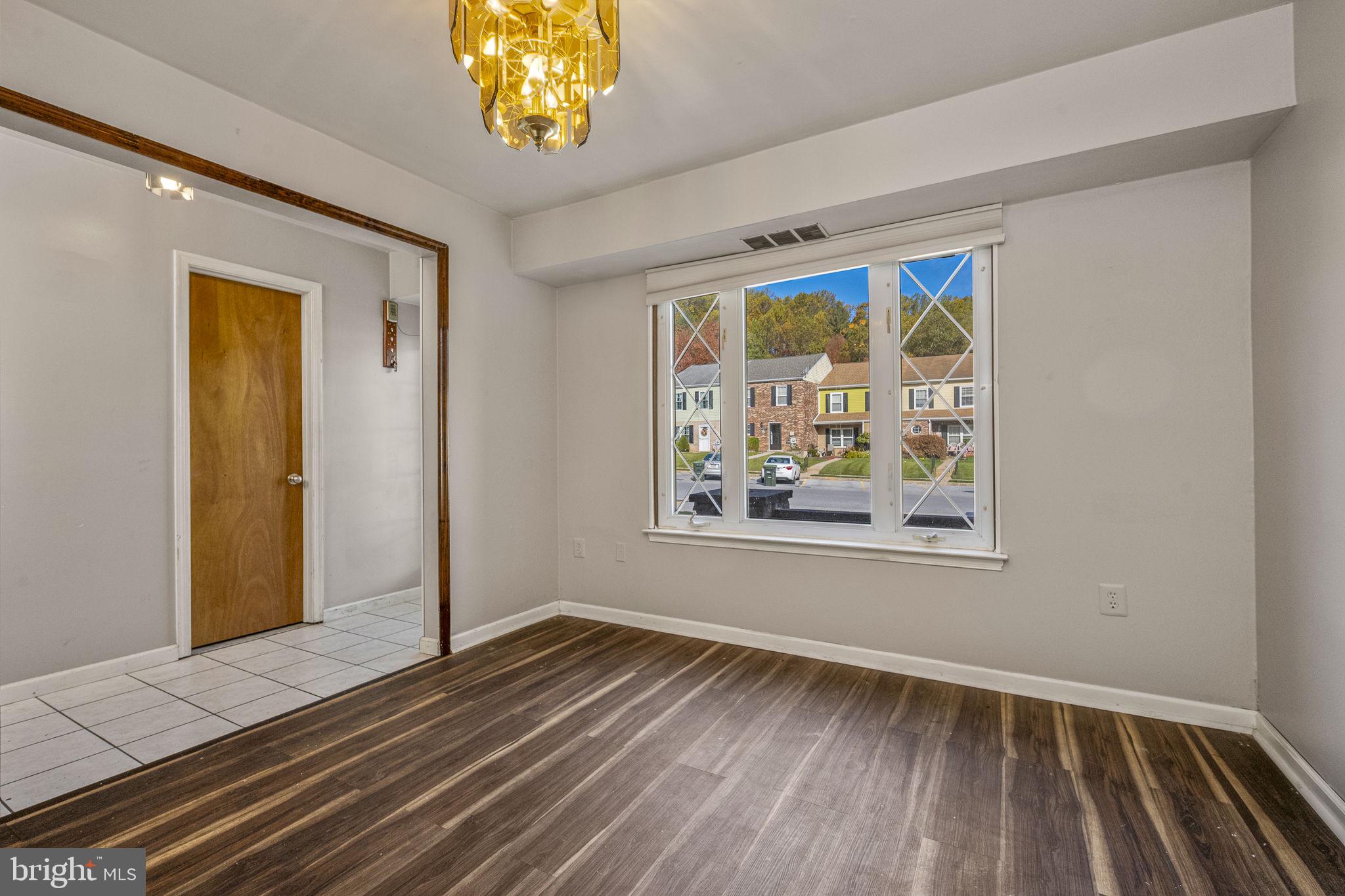 2550 Clothier Street Coatesville, PA 19320 - Photo 6 of 23 a view of an empty room with a window and wooden floor