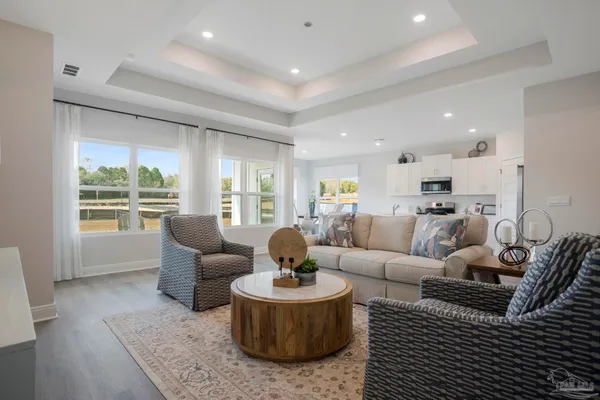 a dining hall with stainless steel appliances granite countertop a sink and dishwasher with wooden floor