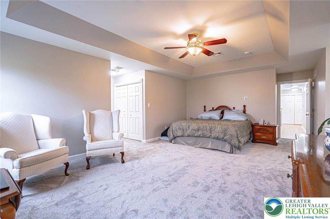 6551 Overlook Road Orefield, PA 18069 - Photo 41 of 82 a spacious bedroom with a bed and a chandelier