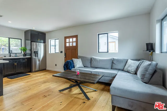 a living room with a couch and windows