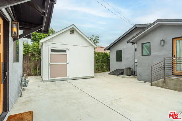 a view of house with backyard and glass windows