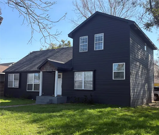 a brick house that has a small yard