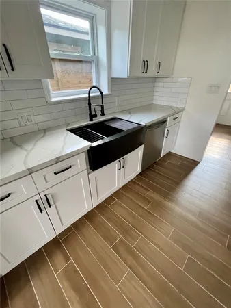 a kitchen with granite countertop a sink and a stove