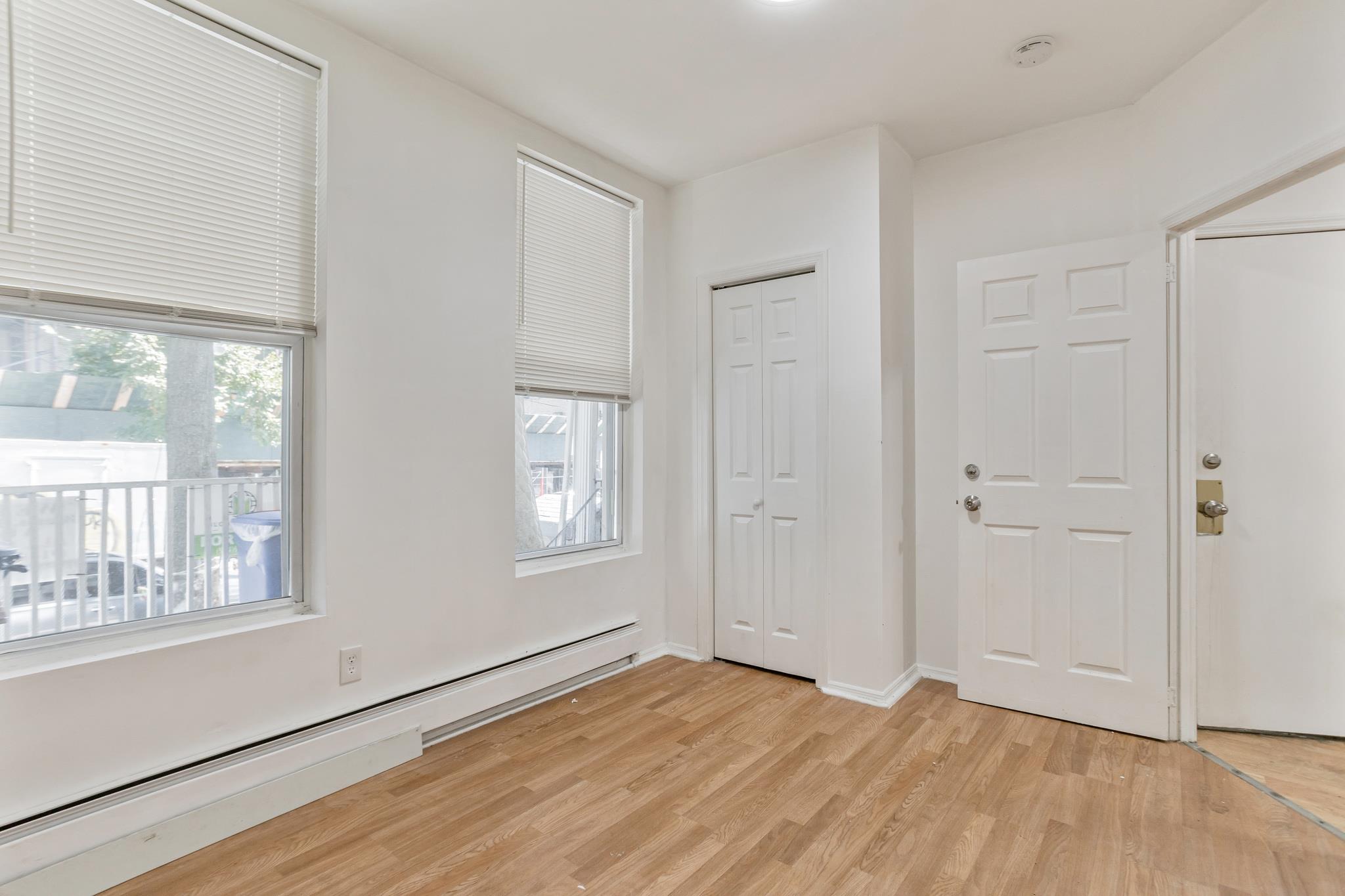 2263 Ryer Avenue Bronx, NY 10457 - Photo 13 of 49 Entrance foyer with a baseboard radiator and light wood-type flooring