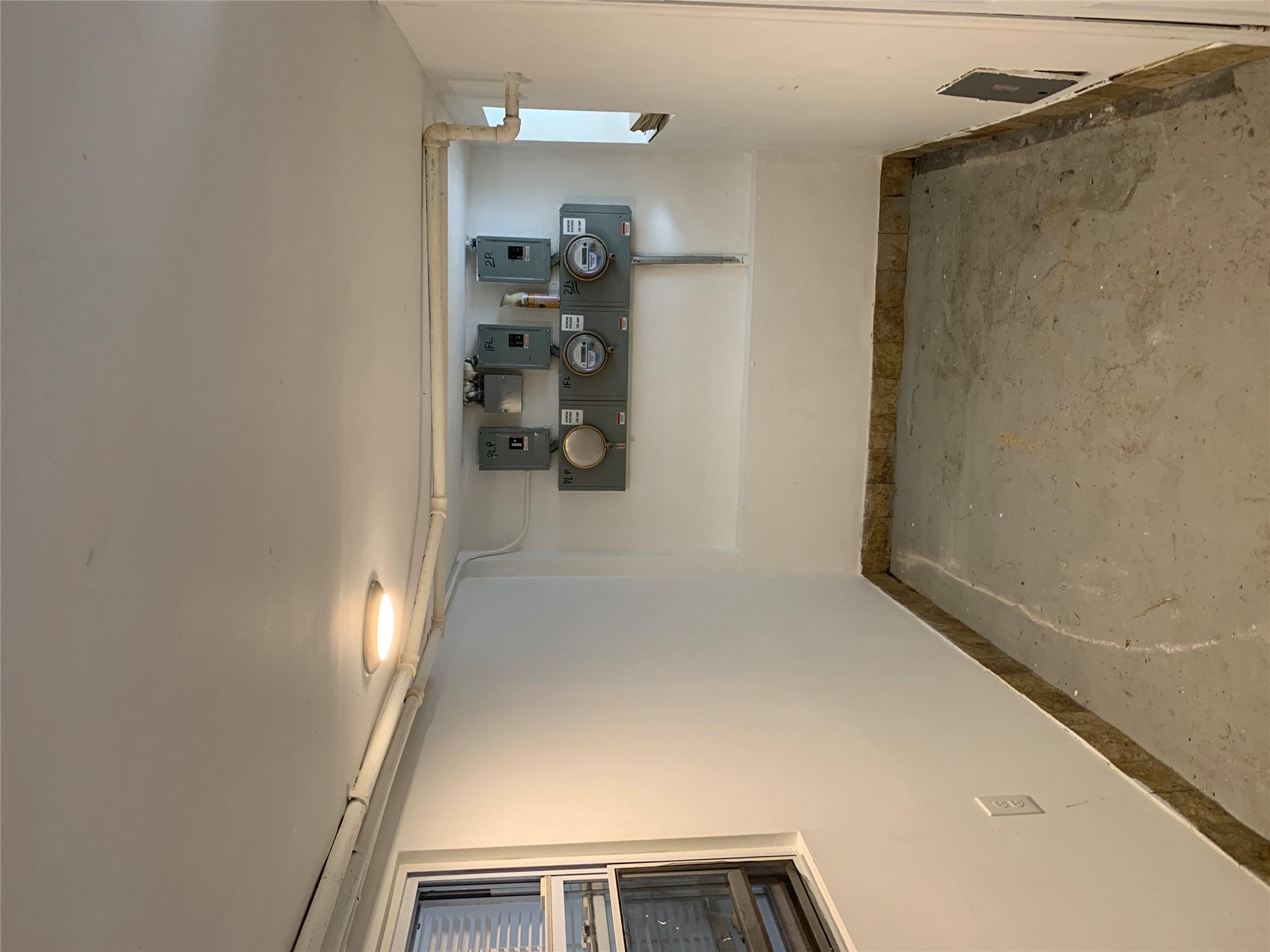 2263 Ryer Avenue Bronx, NY 10457 - Photo 20 of 49 Basement featuring electric panel and baseboards