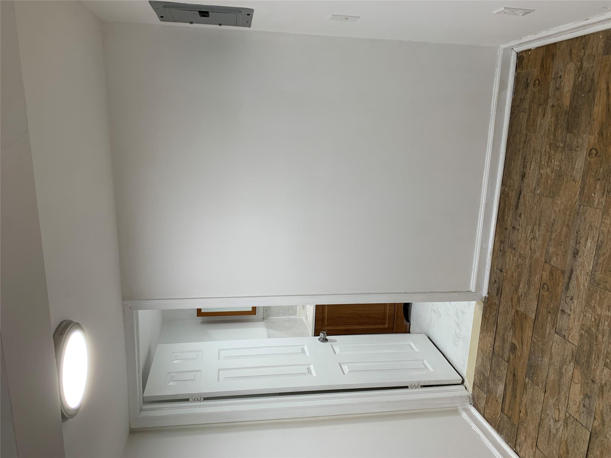 2263 Ryer Avenue Bronx, NY 10457 - Photo 25 of 49 Hall with electric panel, baseboards, and hardwood / wood-style floors