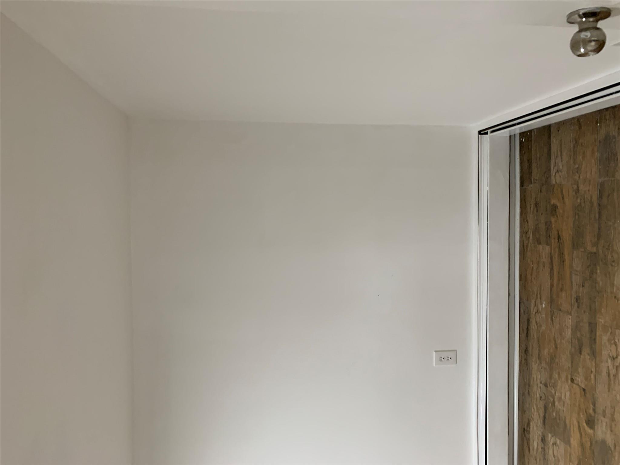 2263 Ryer Avenue Bronx, NY 10457 - Photo 36 of 49 Unfurnished room featuring a baseboard radiator, baseboard heating, wood finished floors, and baseboards