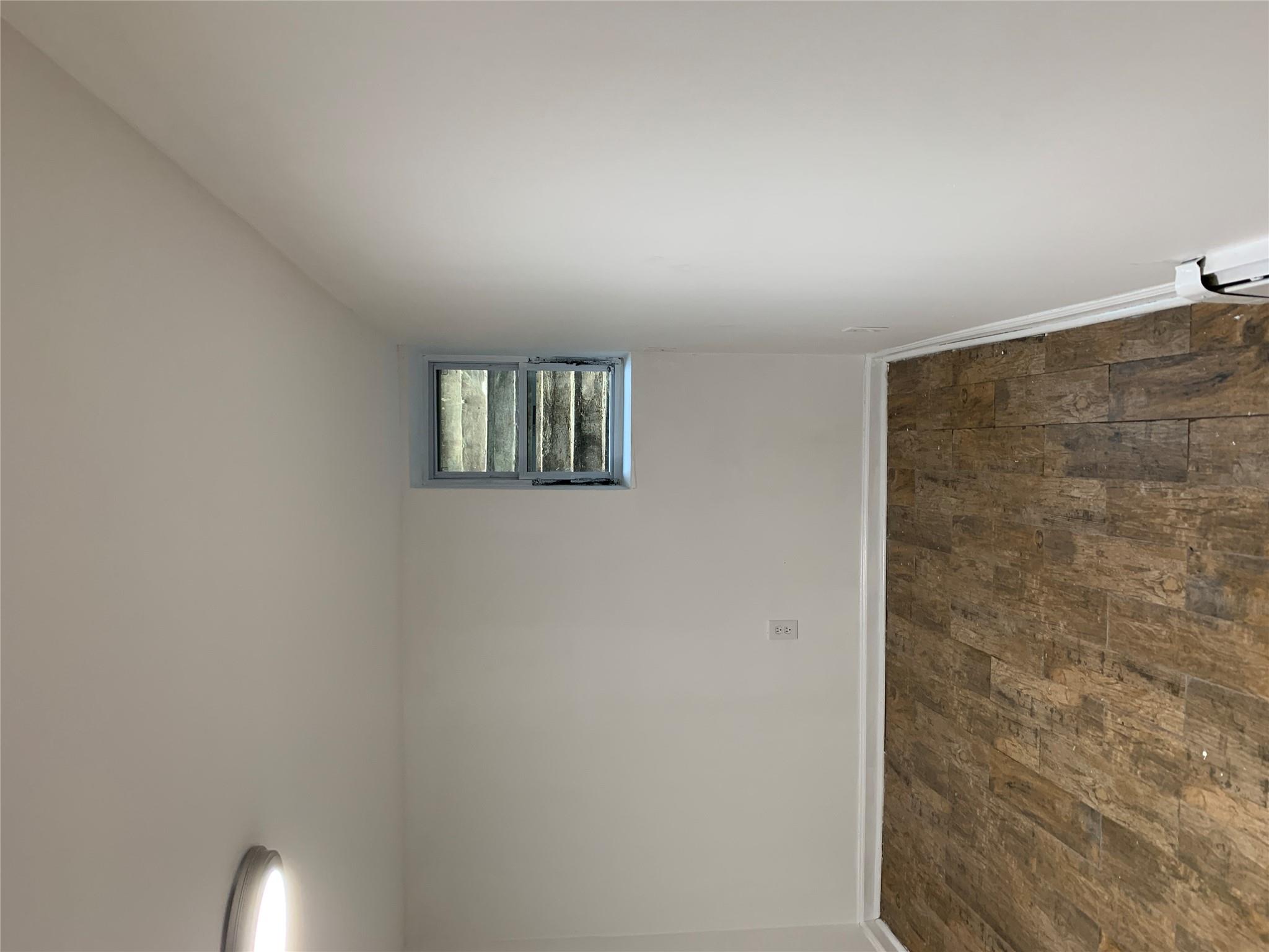 2263 Ryer Avenue Bronx, NY 10457 - Photo 37 of 49 Spare room with wood-type flooring, a baseboard radiator, and baseboards