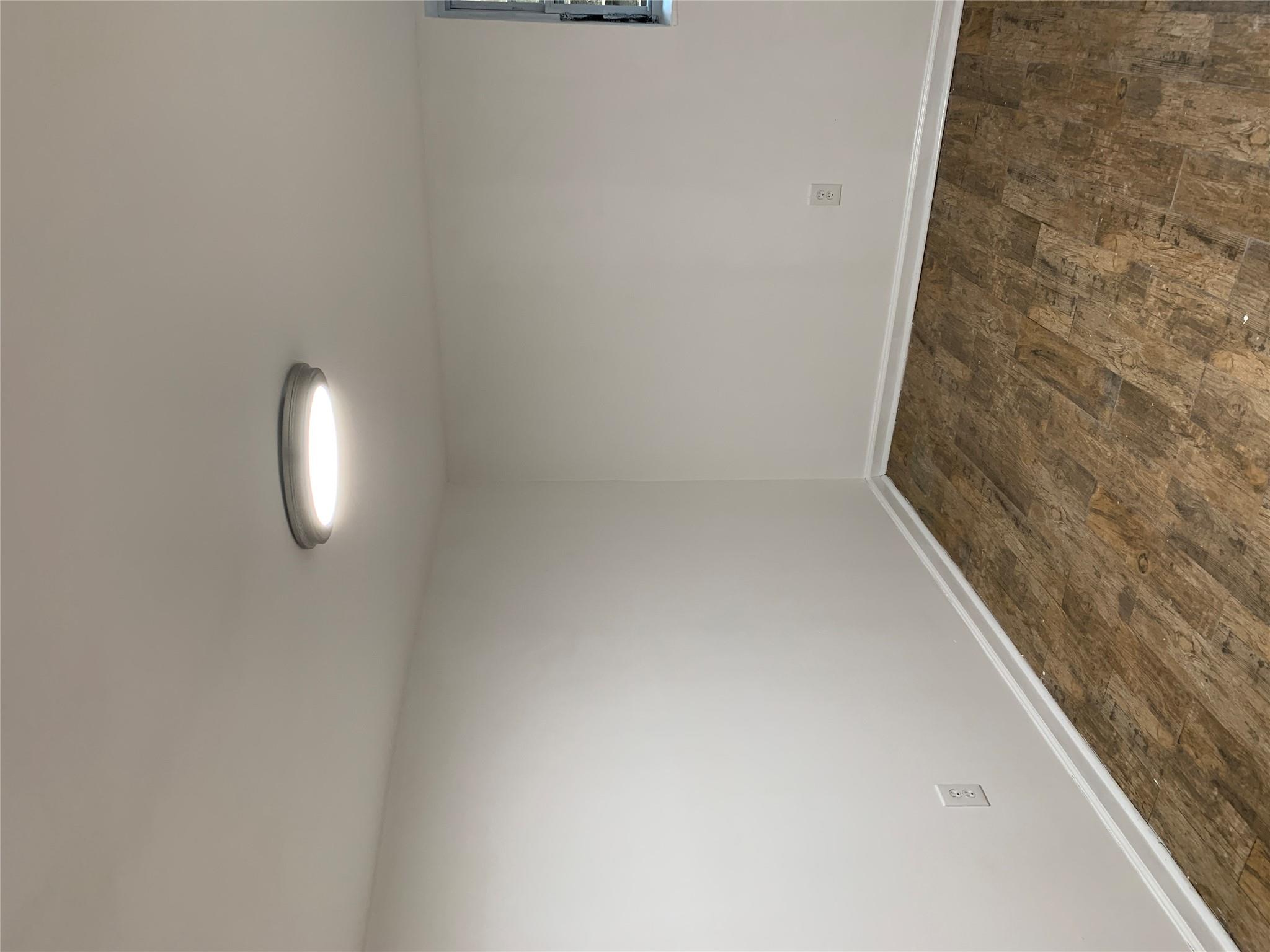 2263 Ryer Avenue Bronx, NY 10457 - Photo 38 of 49 Spare room with dark wood-style floors and baseboards