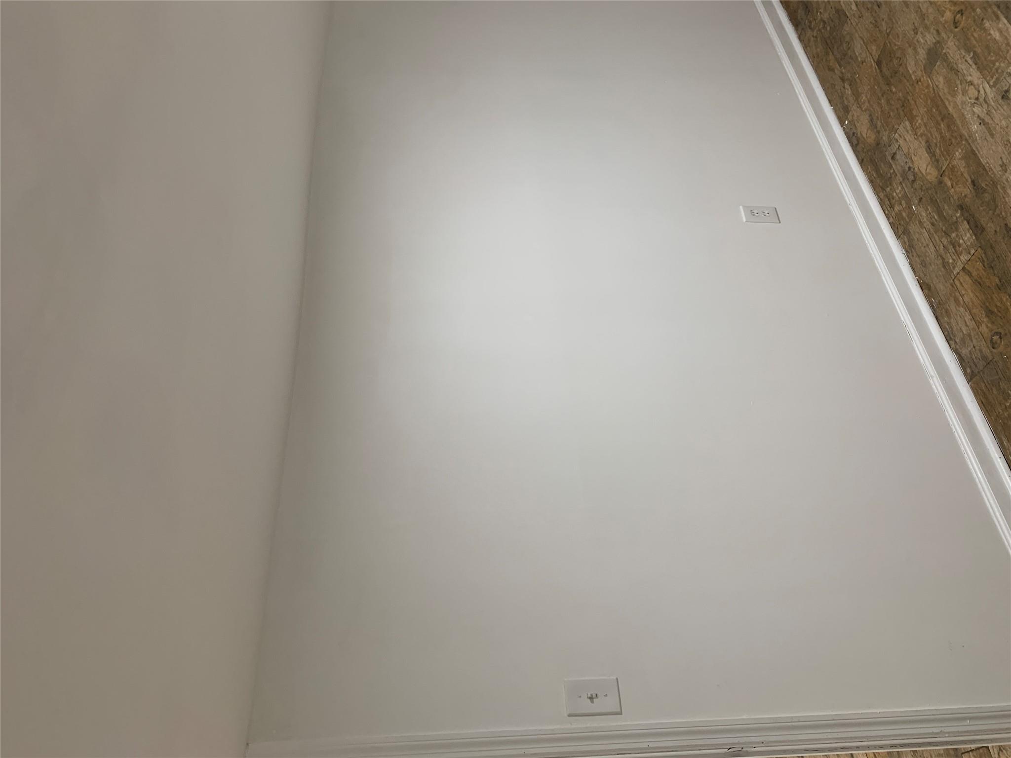 2263 Ryer Avenue Bronx, NY 10457 - Photo 39 of 49 Unfurnished room with dark wood-style floors and baseboards