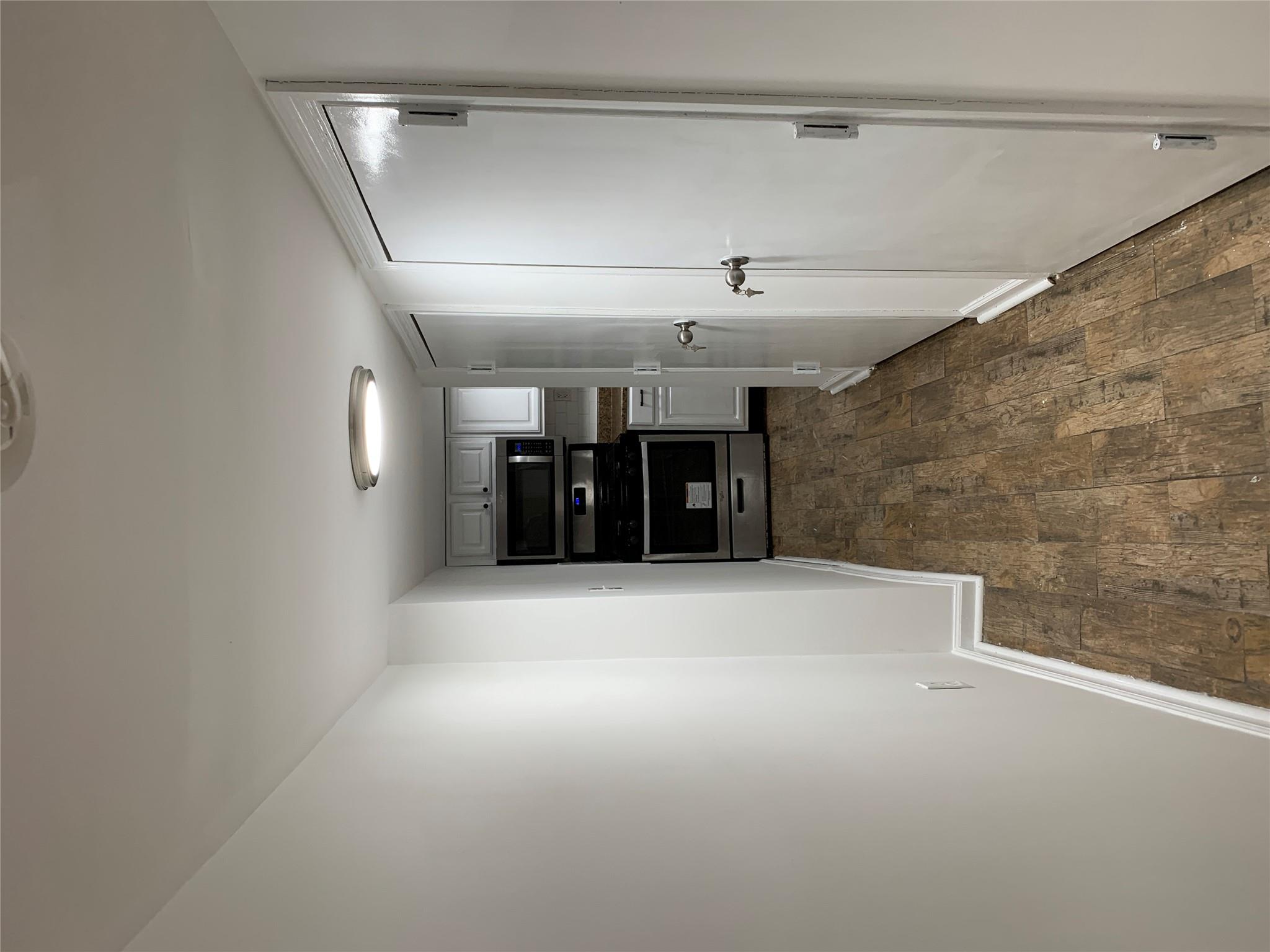 2263 Ryer Avenue Bronx, NY 10457 - Photo 41 of 49 Hall featuring baseboards and dark wood-type flooring