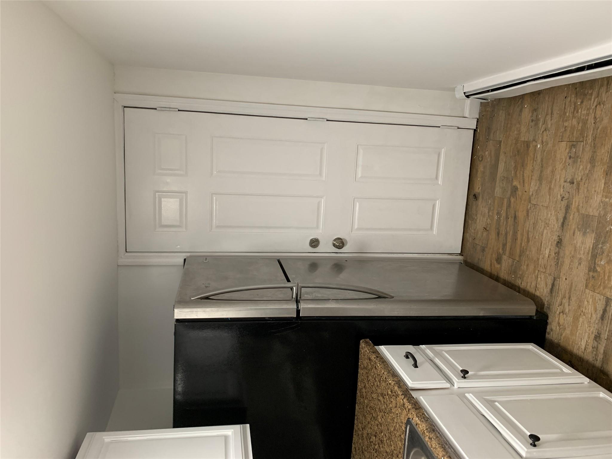 2263 Ryer Avenue Bronx, NY 10457 - Photo 44 of 49 Kitchen featuring white cabinetry, dark wood finished floors, fridge, dark countertops, and a baseboard heating unit