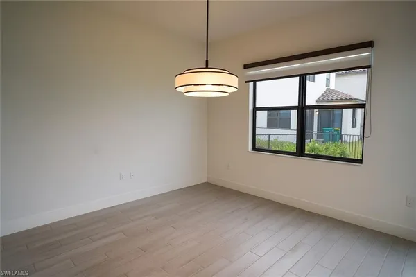 a view of a room with wooden floor and a window