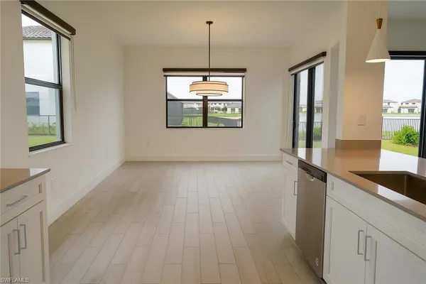 a view of a room with wooden floor and windows