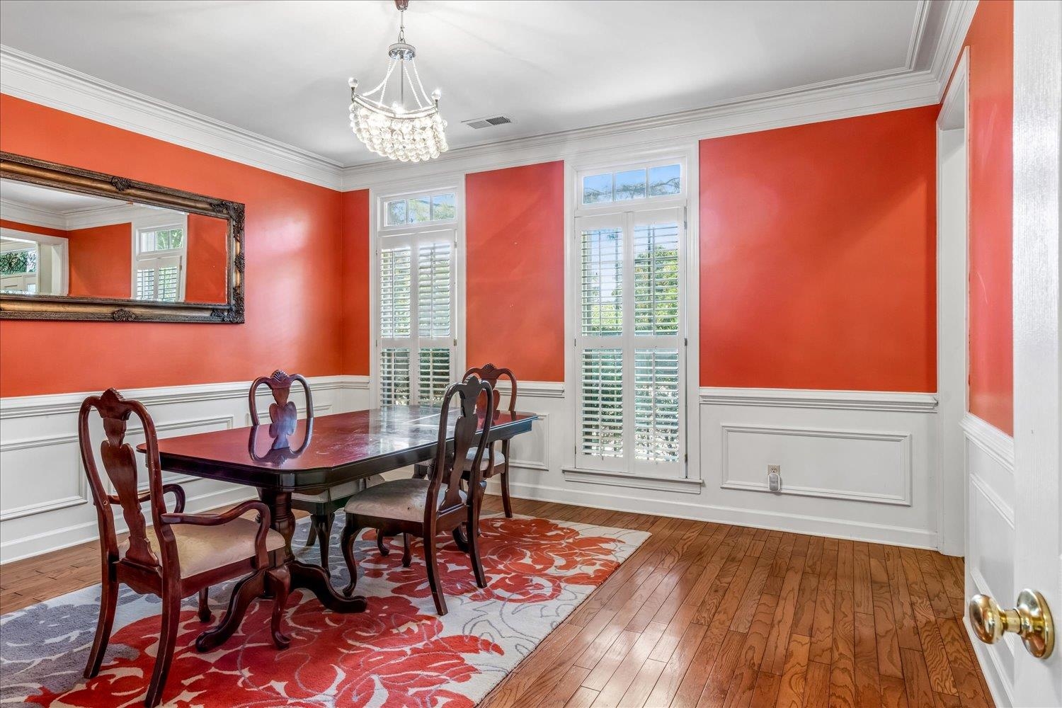 65 Summer Grove Road Memphis, TN 38018 - Photo 21 of 38 Wood-finish flooring, white paneled wainscoting, crown molding, and a crystal chandelier