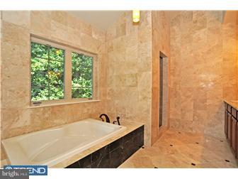 449 West Valley Road Wayne, PA 19087 - Photo 11 of 12 a bathroom with a bathtub and a shower