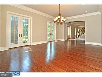 449 West Valley Road Wayne, PA 19087 - Photo 4 of 12 a view of an empty room with wooden floor and a chandelier