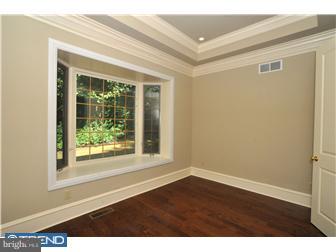 449 West Valley Road Wayne, PA 19087 - Photo 5 of 12 a view of an empty room with wooden floor and a window