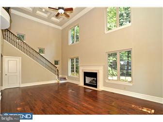 449 West Valley Road Wayne, PA 19087 - Photo 8 of 12 a view of an empty room with wooden floor fireplace and a window